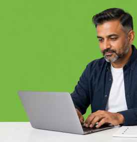UK small business owner setting up a business email at a domain on a laptop, with a notepad of DNS settings beside the keyboard.
