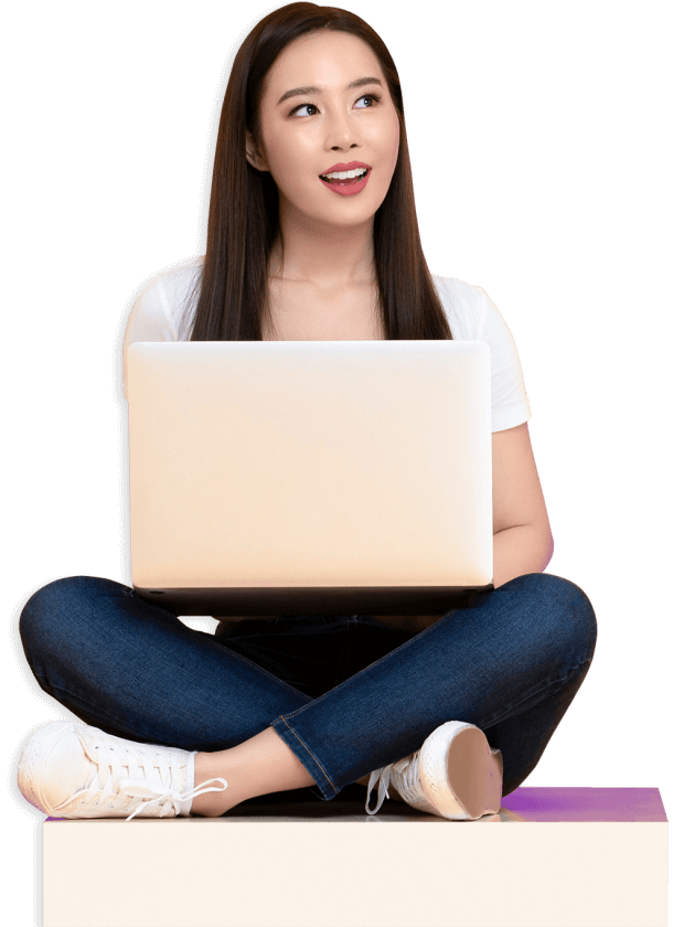 A woman siting with a laptop smiling