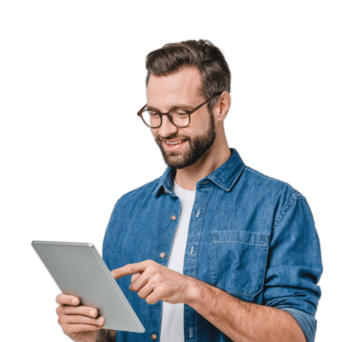 smiling man stands looking at a tablet