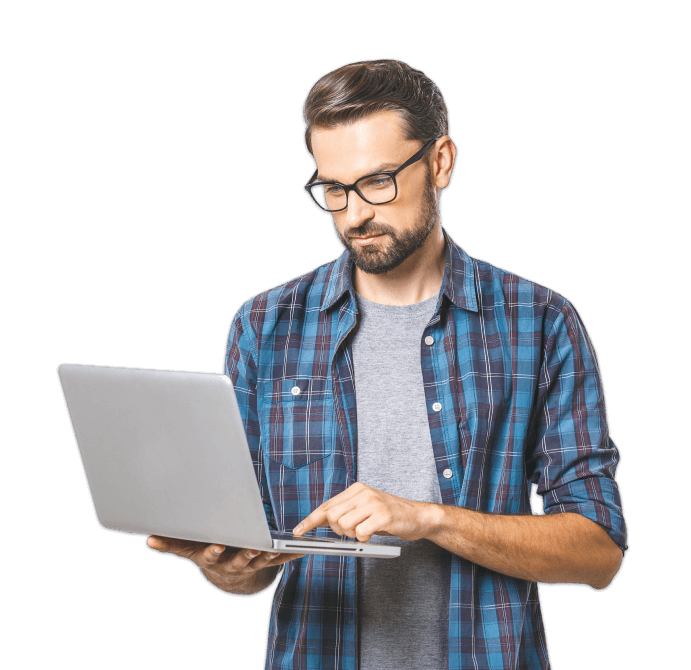 smiling man stands with open laptop