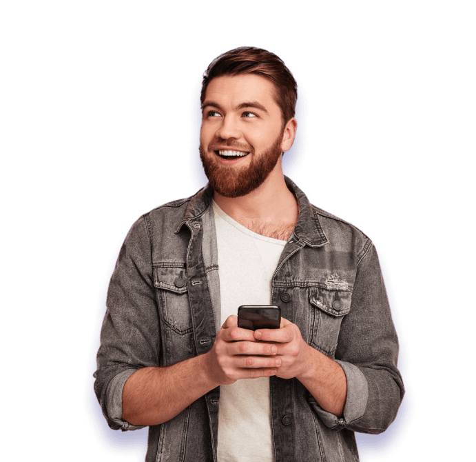 smiling man stands with a phone