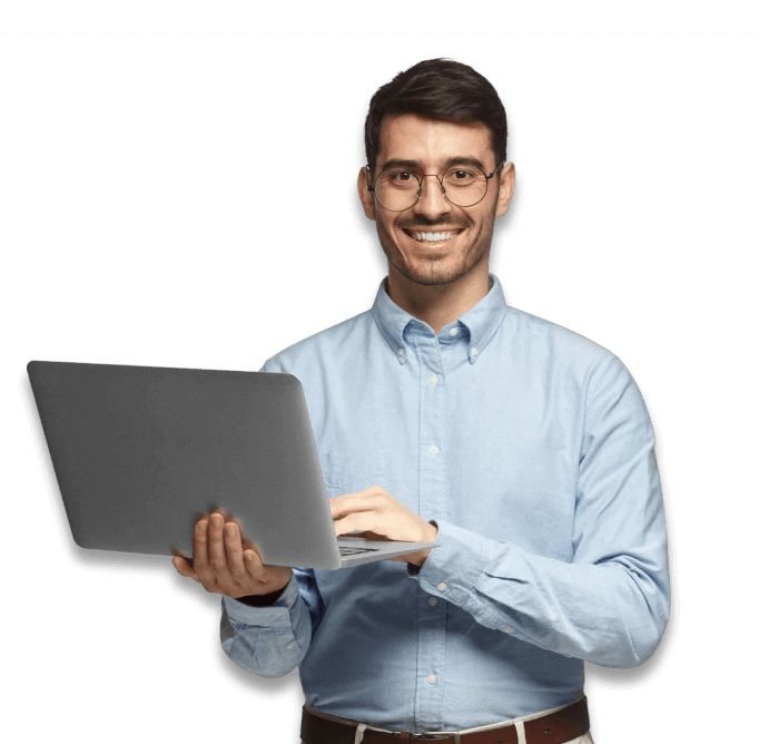 smiling man stands with open laptop